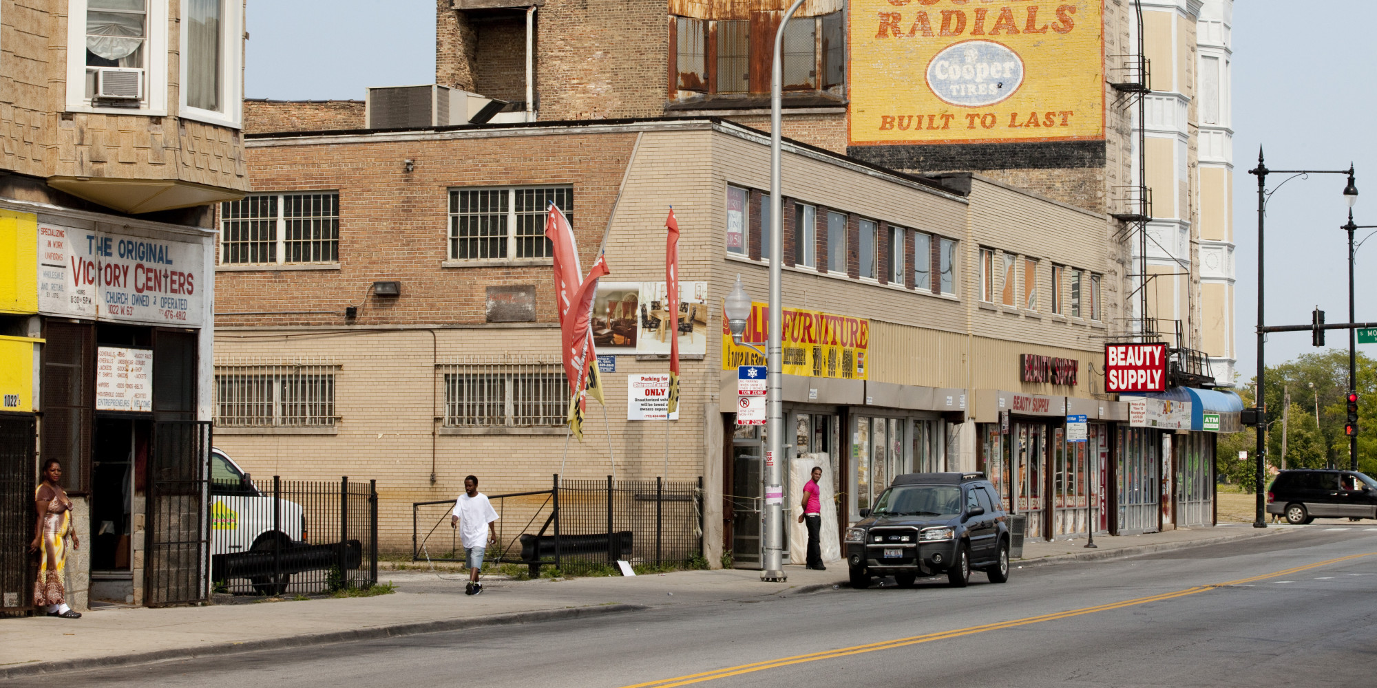 CHICAGO, IL - AUGUST 19: People walk through a commercial area in the Englewood neighborhood, on August 19, 2013 in Chicago, Illinois. Englewood is a depressed neighborhood of Chicago with a high crime rate that has been hit even harder by the sluggish economy. Some people are moving out to the suburbs to escape the violence. (Photo by Melanie Stetson Freeman/The Christian Science Monitor via Getty Images)